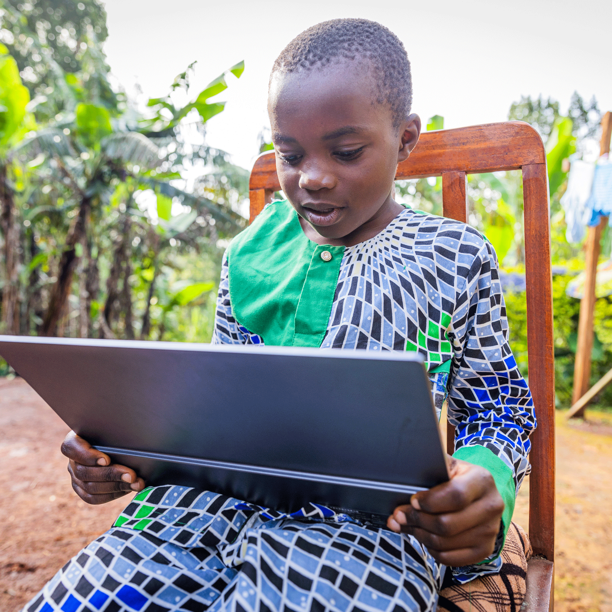 african-young-student-sitting-outdoors-keen-his-tablet-rehearsing-his-lessons-min