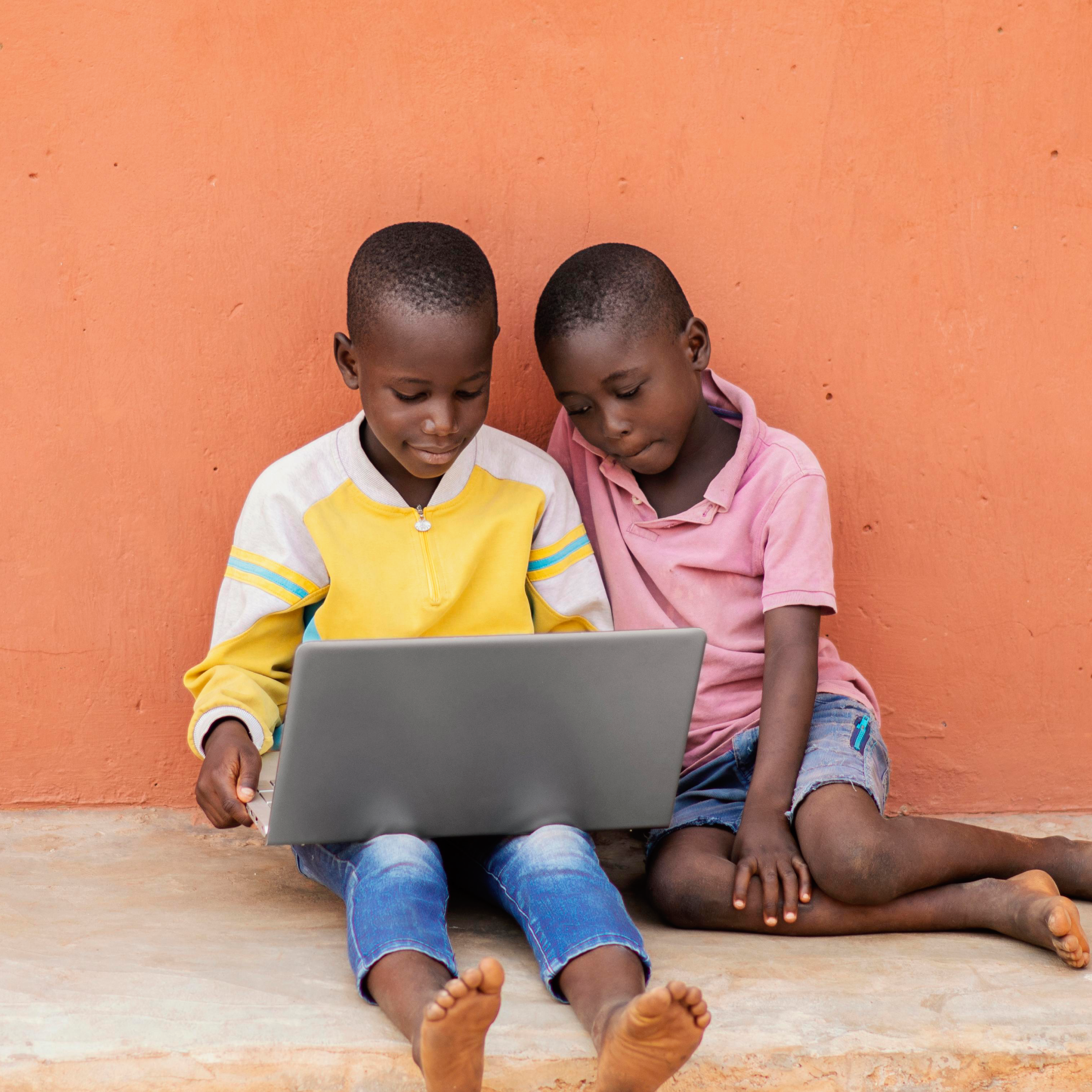 full-shot-african-kids-with-laptop
